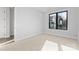 Cozy bedroom featuring neutral carpet, bright windows, and ample natural light at 3437 Byrnes St, Charlotte, NC 28205