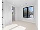 Bedroom with a bright, neutral color palette with black-trimmed windows at 3437 Byrnes St, Charlotte, NC 28205