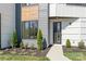Modern home featuring a gray and white exterior with manicured landscaping at 3437 Byrnes St, Charlotte, NC 28205