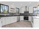 Bright kitchen featuring white cabinets, stainless steel appliances, and dark backsplash at 3437 Byrnes St, Charlotte, NC 28205