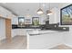 Bright and spacious kitchen featuring white cabinets, stainless steel appliances, and pendant lighting at 3437 Byrnes St, Charlotte, NC 28205