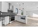 Modern kitchen featuring white cabinetry, herringbone backsplash, and stainless steel appliances at 3437 Byrnes St, Charlotte, NC 28205