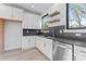 Well-lit kitchen with stainless steel appliances, floating shelves, stylish backsplash, and ample counter space at 3437 Byrnes St, Charlotte, NC 28205