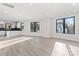 Open floor plan with black frame windows, modern flooring, and a view of the kitchen at 3437 Byrnes St, Charlotte, NC 28205