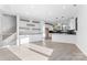Open-concept living space with wood floors, built-in cabinets, and a view of the kitchen at 3437 Byrnes St, Charlotte, NC 28205