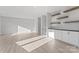 Spacious living room with luxury vinyl floors, recessed lighting, and built-in shelving at 3437 Byrnes St, Charlotte, NC 28205