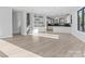 Open living space featuring modern flooring, a staircase, and white kitchen cabinetry at 3437 Byrnes St, Charlotte, NC 28205