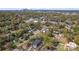 An aerial view showcases the neighborhood, highlighting lush greenery and the cityscape in the distance at 3441 Byrnes St, Charlotte, NC 28205
