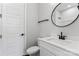 Modern bathroom with white vanity, round mirror, and contemporary fixtures at 3441 Byrnes St, Charlotte, NC 28205