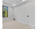 Well-lit bedroom with a window and two stylish paneled doors at 3441 Byrnes St, Charlotte, NC 28205
