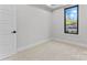Bright bedroom features neutral tones, plush carpeting, and a well-lit window for a cozy atmosphere at 3441 Byrnes St, Charlotte, NC 28205