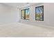 Sunlit bedroom featuring large windows and neutral carpeting at 3441 Byrnes St, Charlotte, NC 28205