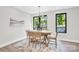 Bright dining area with modern light fixture and natural light from windows and a table for six at 3441 Byrnes St, Charlotte, NC 28205