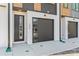 Modern townhome featuring contemporary design, a black garage door, and stylish front entry at 3441 Byrnes St, Charlotte, NC 28205