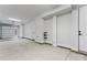 Spacious garage featuring a roll-up door, smooth concrete floors and white walls at 3441 Byrnes St, Charlotte, NC 28205