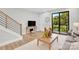 Bright living room with a cozy sitting area with large windows and natural light at 3441 Byrnes St, Charlotte, NC 28205