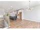 Open-concept living area into a kitchen with modern finishes, hardwood floors, and a light fixture at 3441 Byrnes St, Charlotte, NC 28205