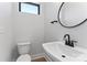Stylish half-bathroom with a modern vessel sink, round mirror, and minimalist decor at 3441 Byrnes St, Charlotte, NC 28205