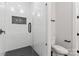 Sleek walk-in shower with white marble tile, dark fixtures, and a modern, minimalist design at 3441 Byrnes St, Charlotte, NC 28205