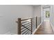 Modern staircase featuring wood and black metal railings, leading to upper levels of the home at 3441 Byrnes St, Charlotte, NC 28205