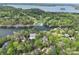 Aerial view showcasing the home's proximity to a golf course and lake, surrounded by trees at 345 Porters Glen None, New London, NC 28127
