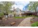 Expansive backyard with a stone walkway, mature trees, and a charming water feature at 345 Porters Glen None, New London, NC 28127