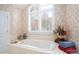 Bathroom featuring a soaking tub, floral wallpaper, and natural light at 345 Porters Glen None, New London, NC 28127