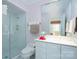 Well-lit bathroom featuring a glass shower door, white vanity, and red accent tiles at 345 Porters Glen None, New London, NC 28127