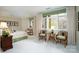 Bedroom featuring neutral walls, complementary green accents, large windows, and sitting area at 345 Porters Glen None, New London, NC 28127