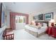 Bright bedroom featuring neutral walls, complementary red and white accents, and a large window overlooking the yard at 345 Porters Glen None, New London, NC 28127