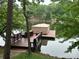 A private boat dock and cover provide convenience and shade on the serene lake, perfect for waterside enjoyment at 345 Porters Glen None, New London, NC 28127