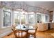 Bright breakfast nook features a glass table, comfortable seating, and large windows overlooking lush greenery at 345 Porters Glen None, New London, NC 28127