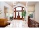 Elegant foyer with tiled floors, transom windows, arched entryway and grand wood door sets a welcoming tone at 345 Porters Glen None, New London, NC 28127