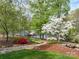 Lake view with brick-paved walkway, manicured lawn, mulched beds, and a quaint boat dock for peaceful lake access at 345 Porters Glen None, New London, NC 28127