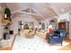 Open living room with vaulted wood ceiling, tiled floors, stone fireplace, and large windows for natural light at 345 Porters Glen None, New London, NC 28127