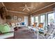 Relaxing sun room with wood paneled ceiling and walls, and lots of seating at 345 Porters Glen None, New London, NC 28127