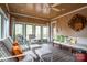 Relaxing sun room with wood paneled ceiling and walls, and lots of seating at 345 Porters Glen None, New London, NC 28127