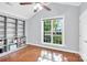 Spacious bedroom with built-in bookshelves, hardwood floors, and a bright window at 3701 Arthur St, Indian Trail, NC 28079