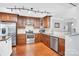 Well-lit kitchen with wood cabinets, stainless steel appliances, and granite countertops at 3701 Arthur St, Indian Trail, NC 28079