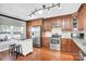 Well-equipped kitchen with stainless steel appliances, dark wood cabinetry, and an island with seating at 3701 Arthur St, Indian Trail, NC 28079