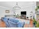 Inviting living room featuring hardwood floors, a large TV, and comfortable seating for relaxation at 3701 Arthur St, Indian Trail, NC 28079