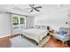 Serene main bedroom featuring tray ceilings, a ceiling fan, and a cozy chair for relaxation at 3701 Arthur St, Indian Trail, NC 28079