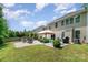 Expansive backyard showcasing a well-maintained lawn, fire pit area, and mature trees, offering a serene outdoor space at 4001 Brook Valley Run, Monroe, NC 28110