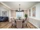 Elegant dining room featuring hardwood floors, stylish chandelier, and seating for six guests at 4001 Brook Valley Run, Monroe, NC 28110