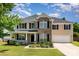 Beautiful two-story home with a well-manicured lawn, charming front porch, and attached two-car garage at 4001 Brook Valley Run, Monroe, NC 28110