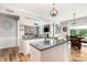 Open kitchen featuring a granite island, stainless steel appliances, and hardwood floors, with a view to breakfast nook at 4001 Brook Valley Run, Monroe, NC 28110
