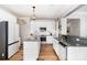 Bright kitchen featuring white cabinetry, stainless steel appliances, granite countertops, and wood-look flooring at 4001 Brook Valley Run, Monroe, NC 28110