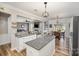 Open-concept kitchen featuring granite counters, white cabinets, and a seamless flow into the dining and living areas at 4001 Brook Valley Run, Monroe, NC 28110