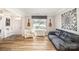 Bright living room with hardwood floors, large window, and comfortable sofa offering ample seating at 4001 Brook Valley Run, Monroe, NC 28110