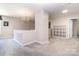 Cozy loft area featuring neutral carpeting, lighting, and a functional built-in shelving unit at 4001 Brook Valley Run, Monroe, NC 28110